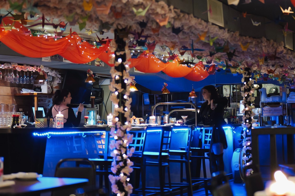 paper cranes hanging from a restaurant ceiling