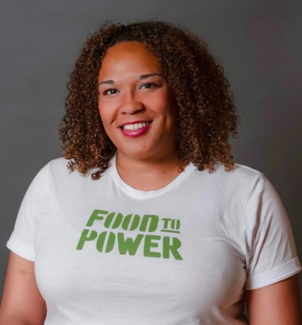 headshot of a woman in a "food to power" t-shirt