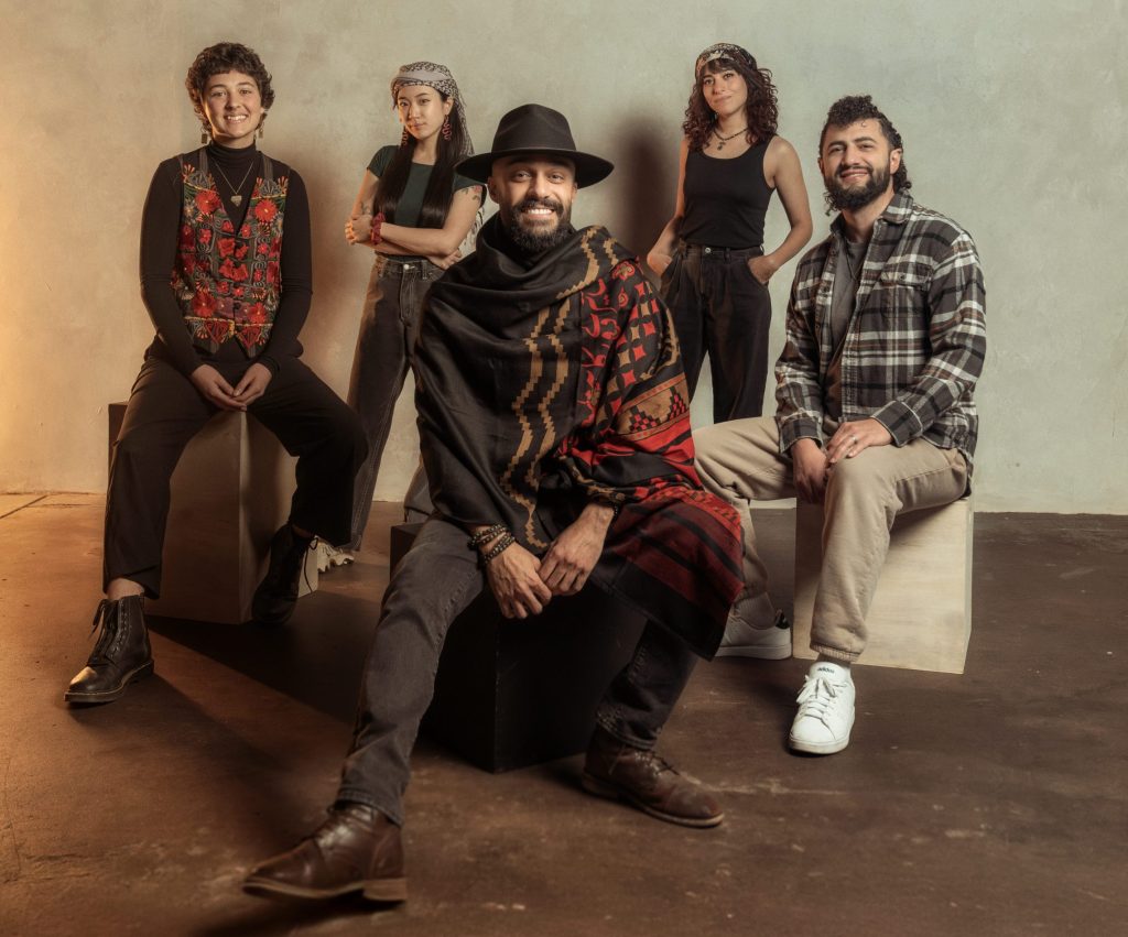 Five people pose together