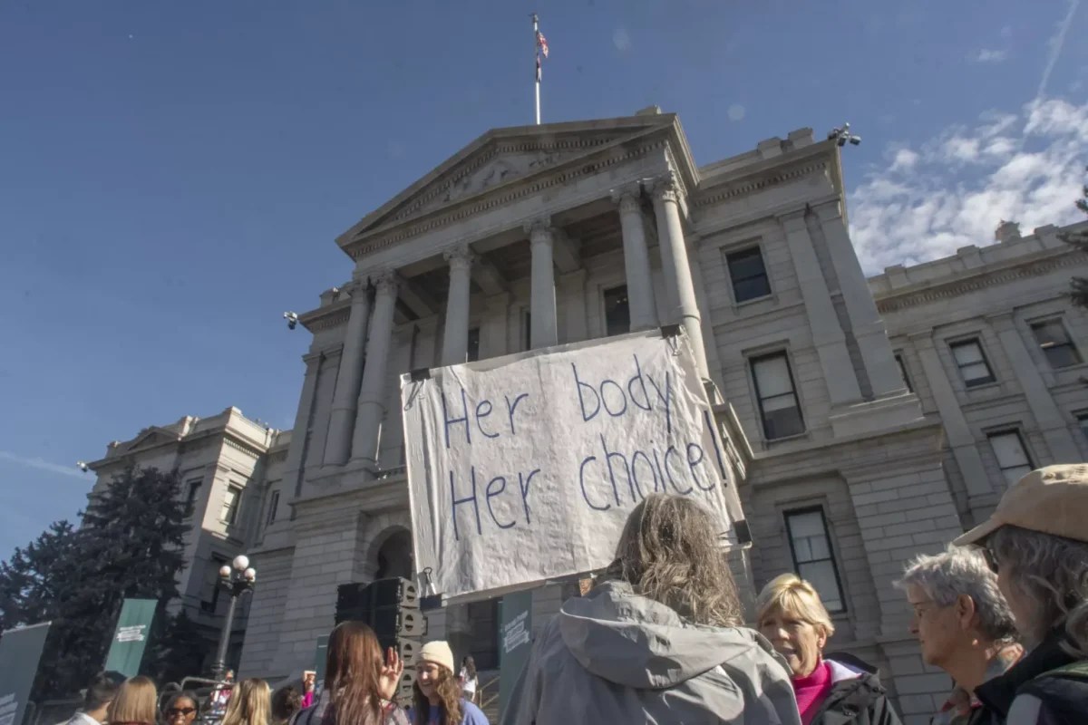 pro-choice protesters hold signs in downtown Denver