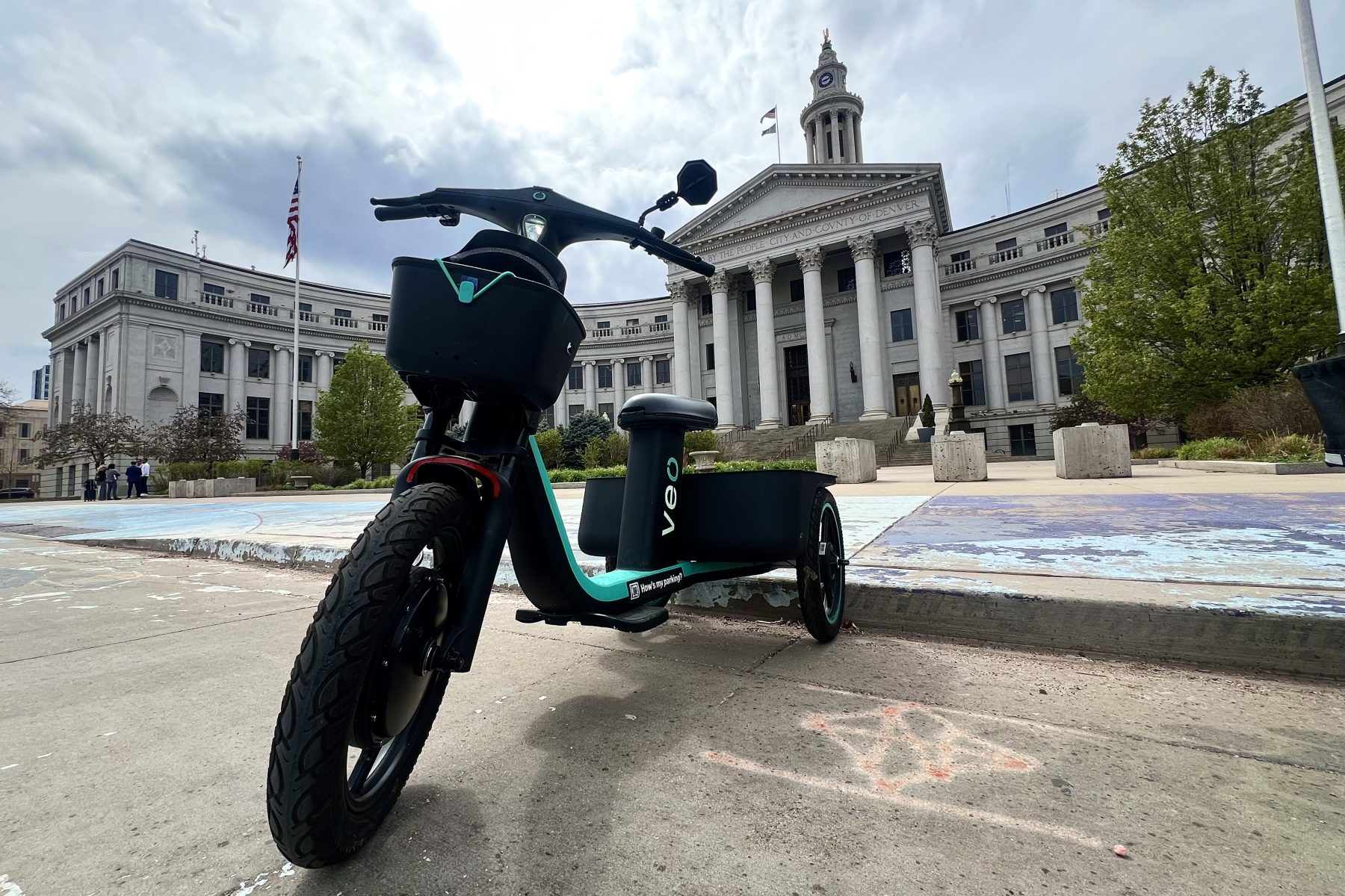 A veo scooter in front of the Denver city and county building