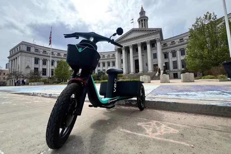 A veo scooter in front of the Denver city and county building