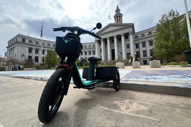 A veo scooter in front of the Denver city and county building