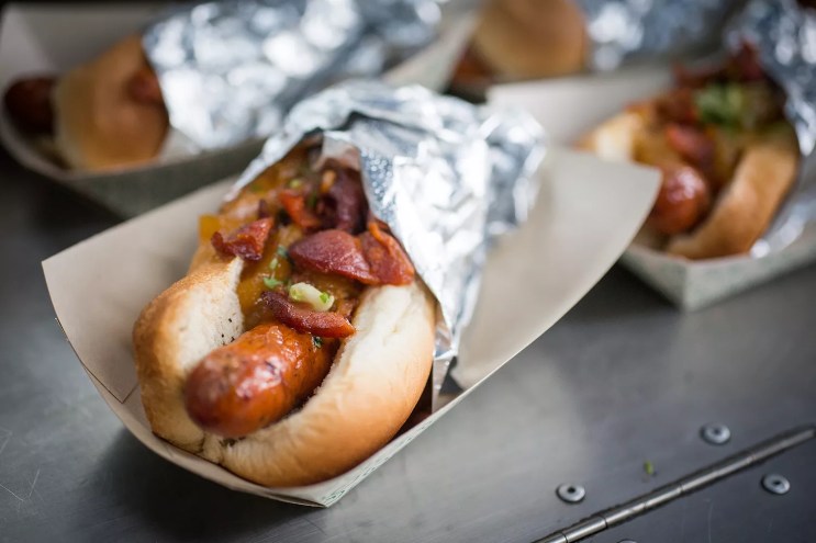 a hot dog wrapped in foil