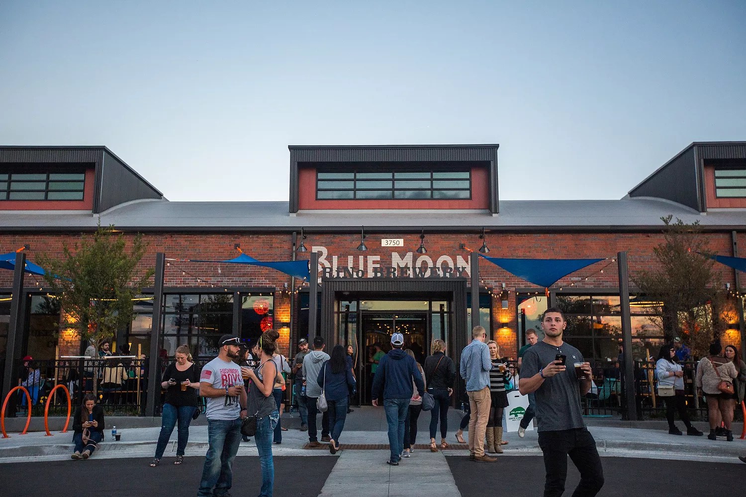 people outside a brick building