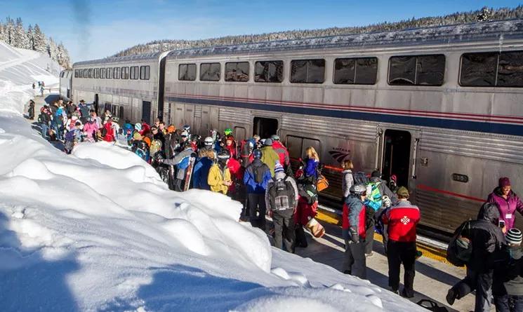 People gather around a train