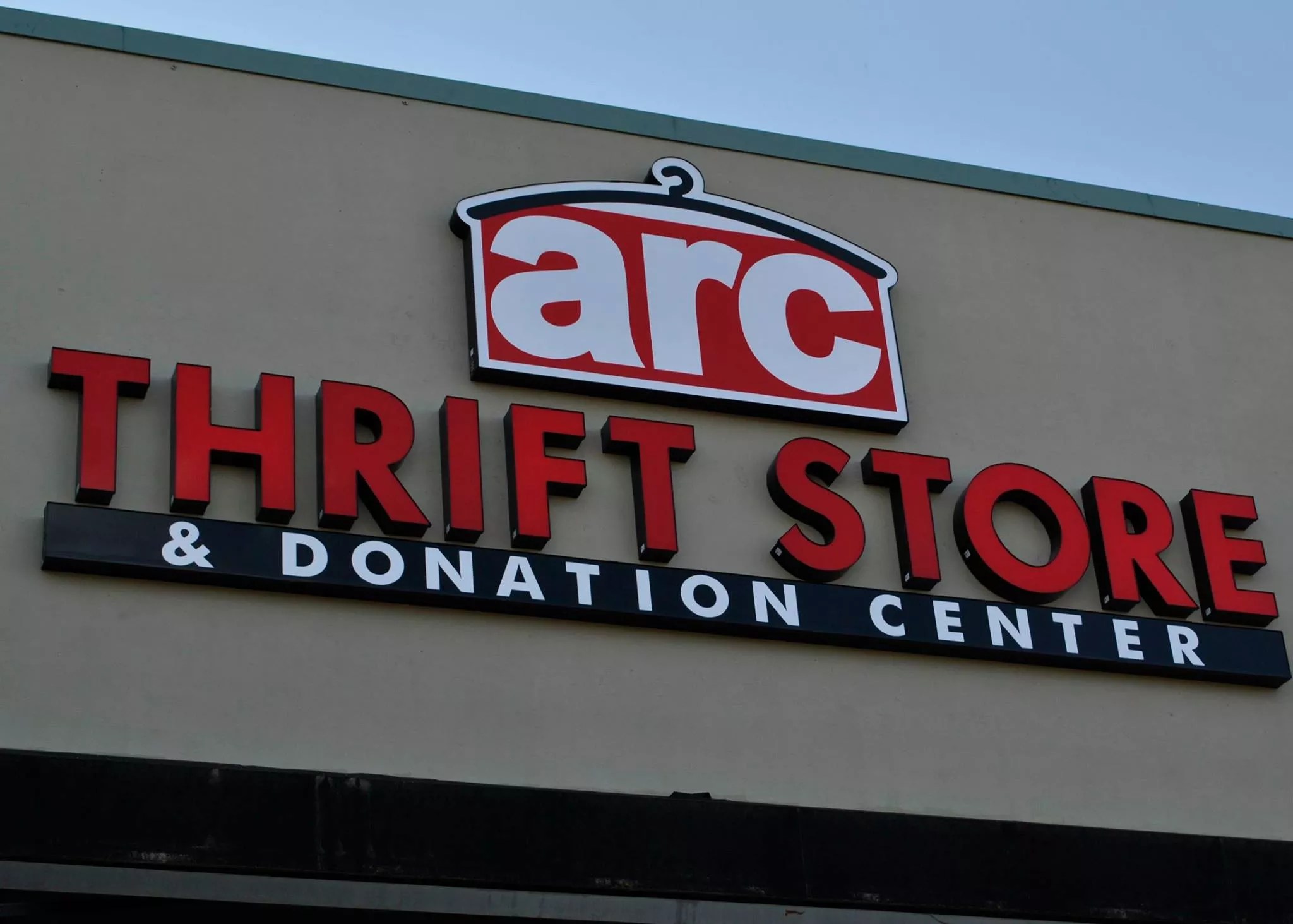 a building with a sign that reads Arc thrift stores.