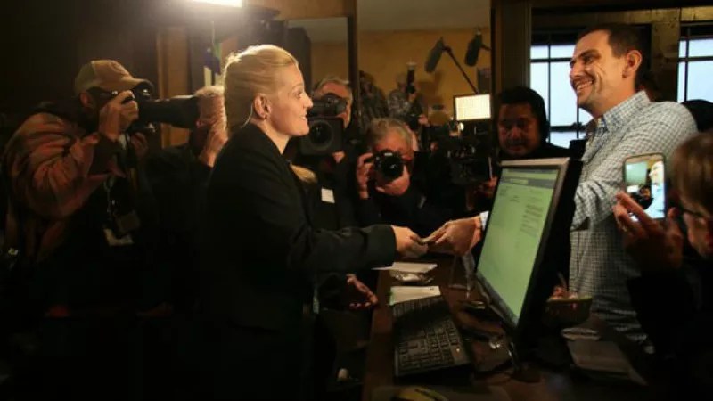 A woman and man conduct the first ever recreational marijuana sales in Denver