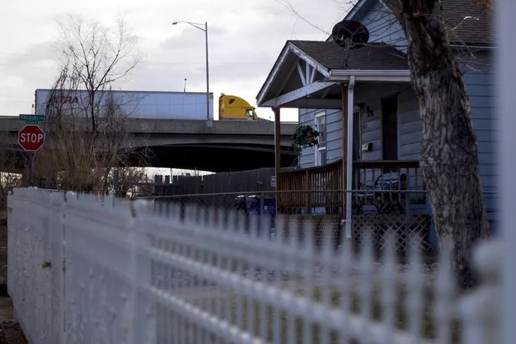 A truck rumbles along the I-70 viaduct above a house in Elyria.