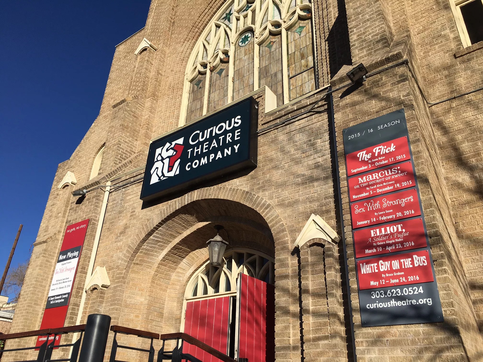 a church with the sign that says Curious Theatre