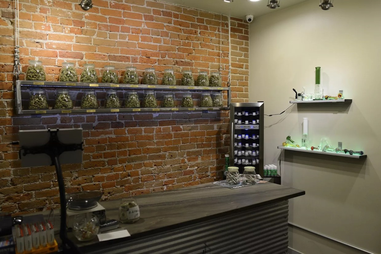A cannabis flower shelf inside of a Denver dispensary