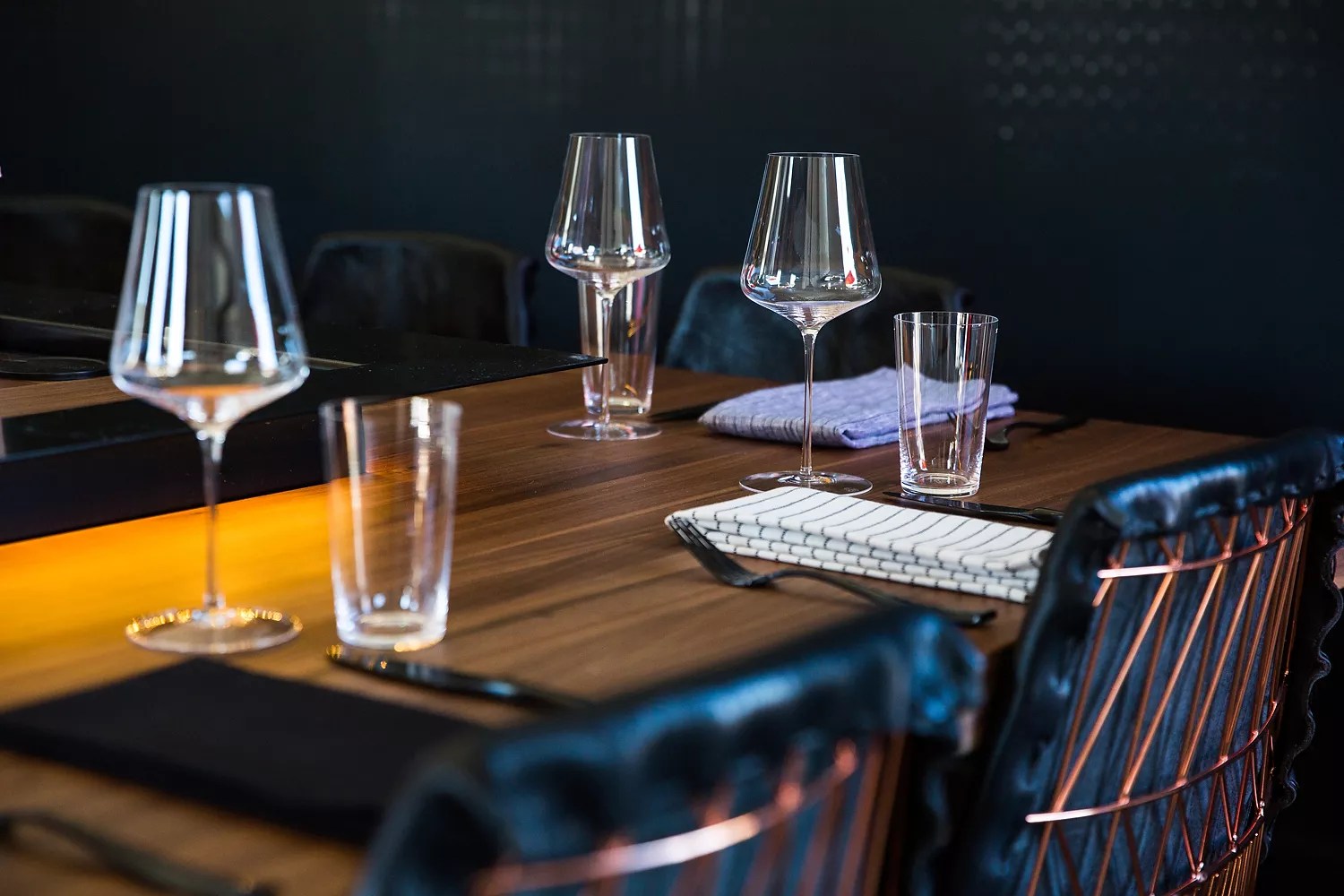 elegant table setting with glasses, black chair