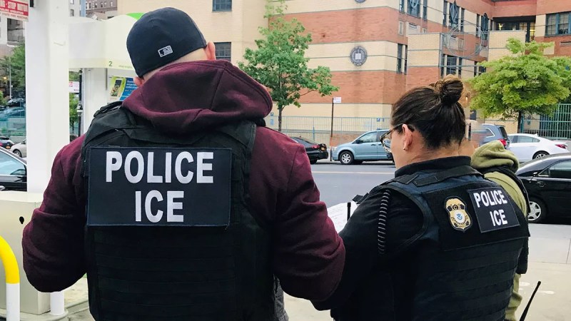 Two officers look at a clipboard.