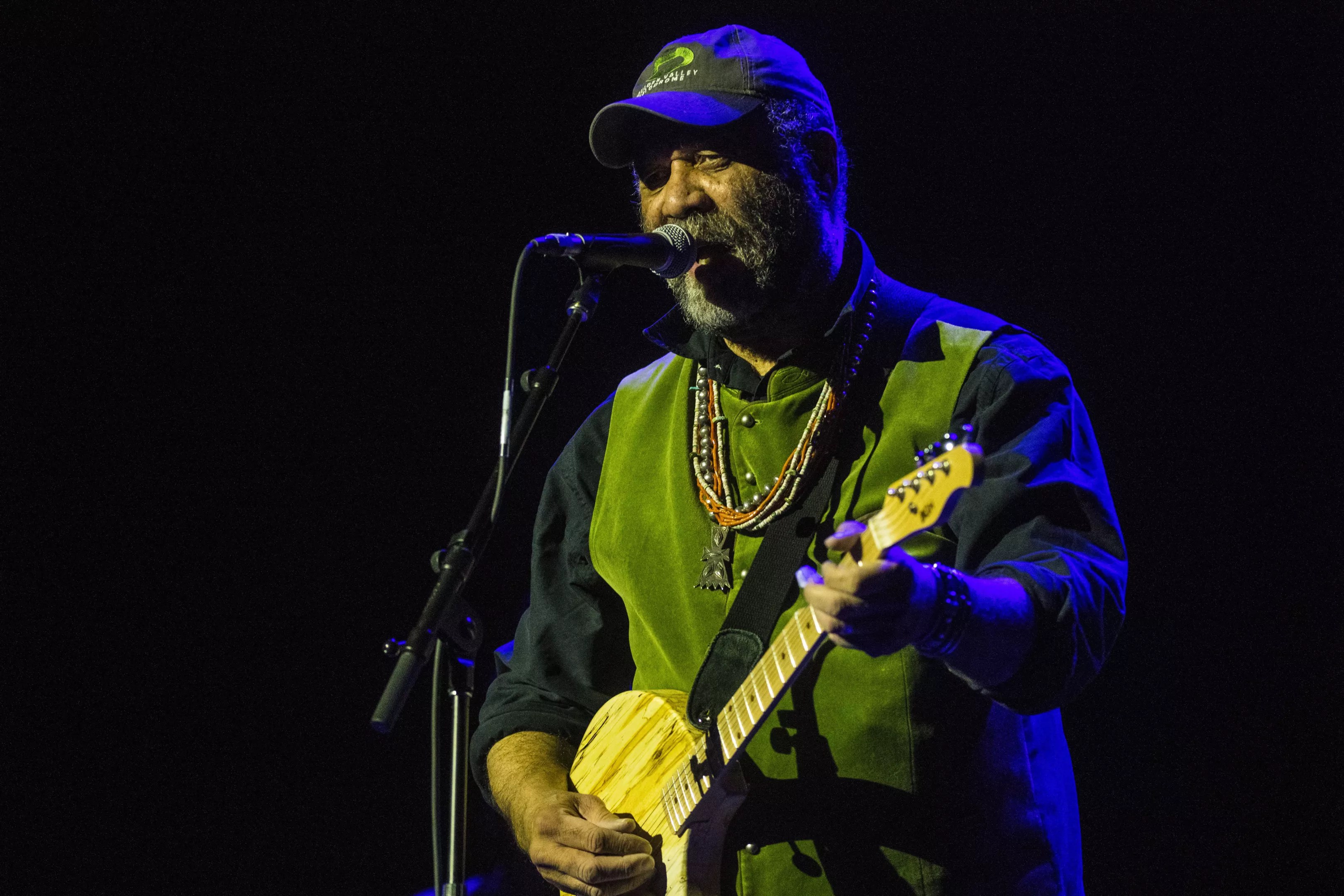 man singing and playing guitar