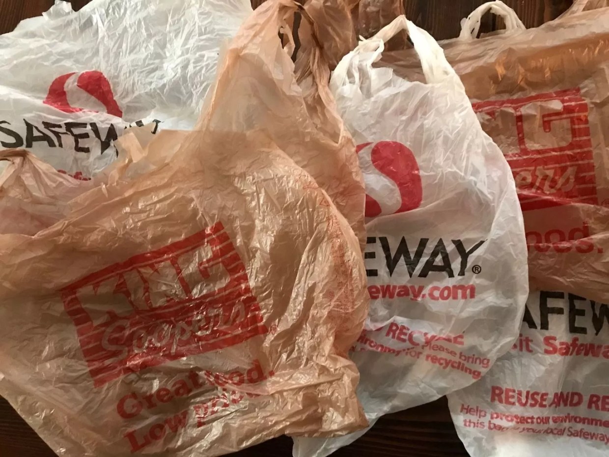 A collection of single-use plastic grocery bags from Safeway and King Soopers.