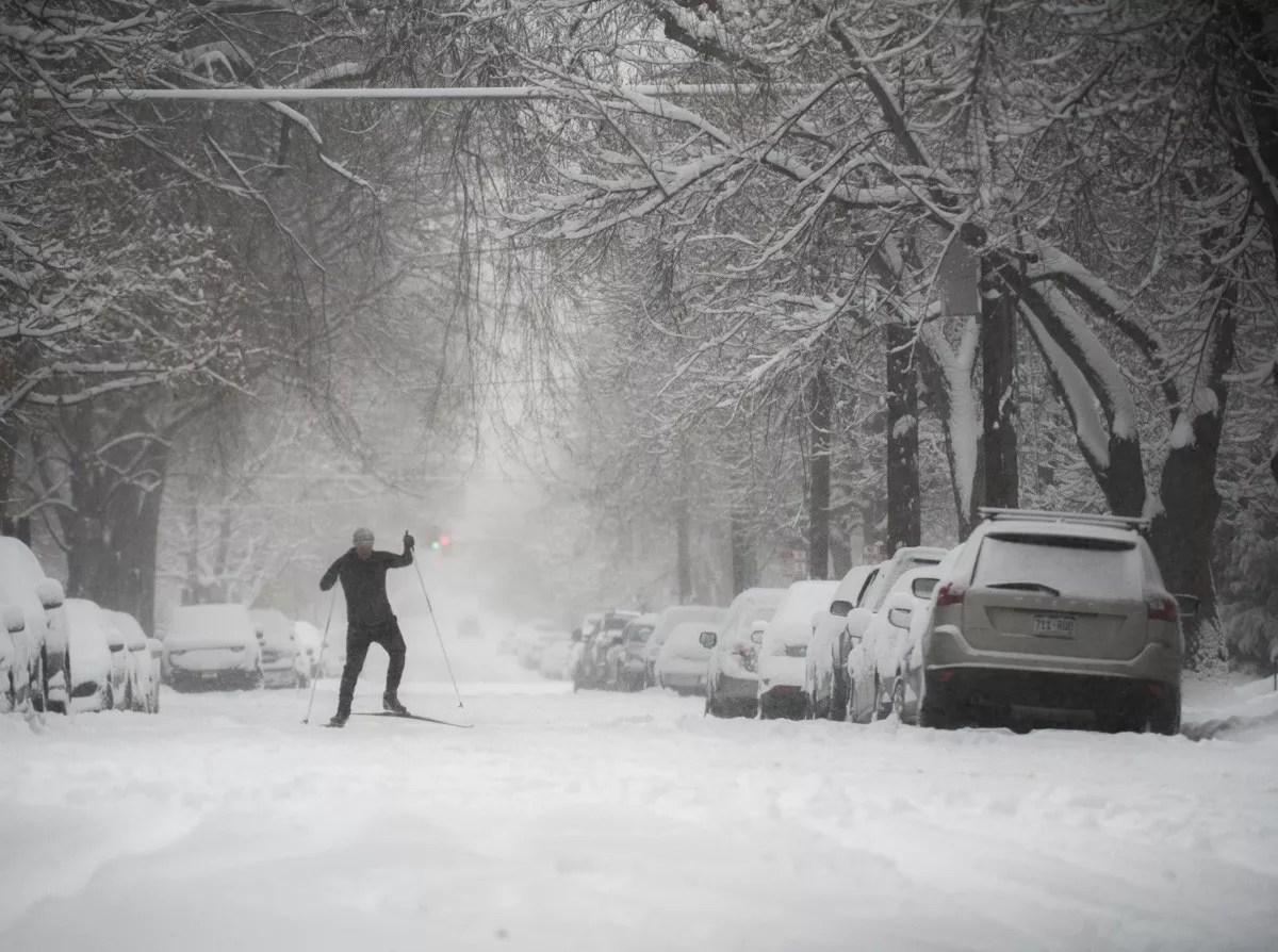 Man snow skates through street