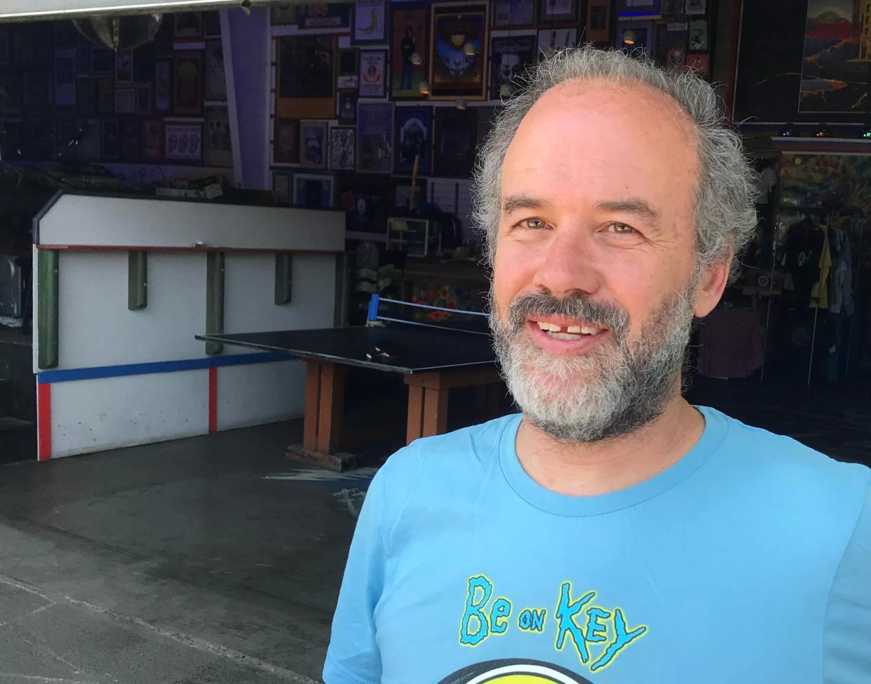 Man in blue shirt on porch