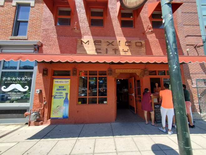 people standing in front of a restaurant