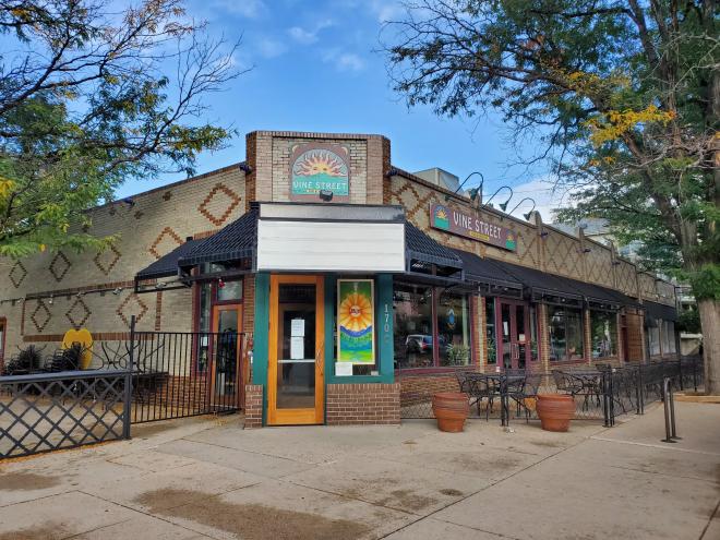 front of a building with a restaurant sign above the entry