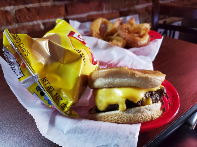 a cheeseburger and a bag of Lay's chips