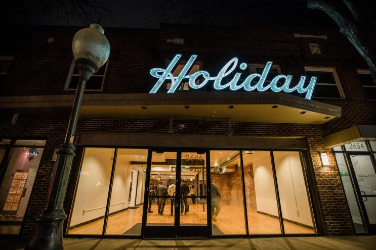 a building with a sign that says Holiday Theater