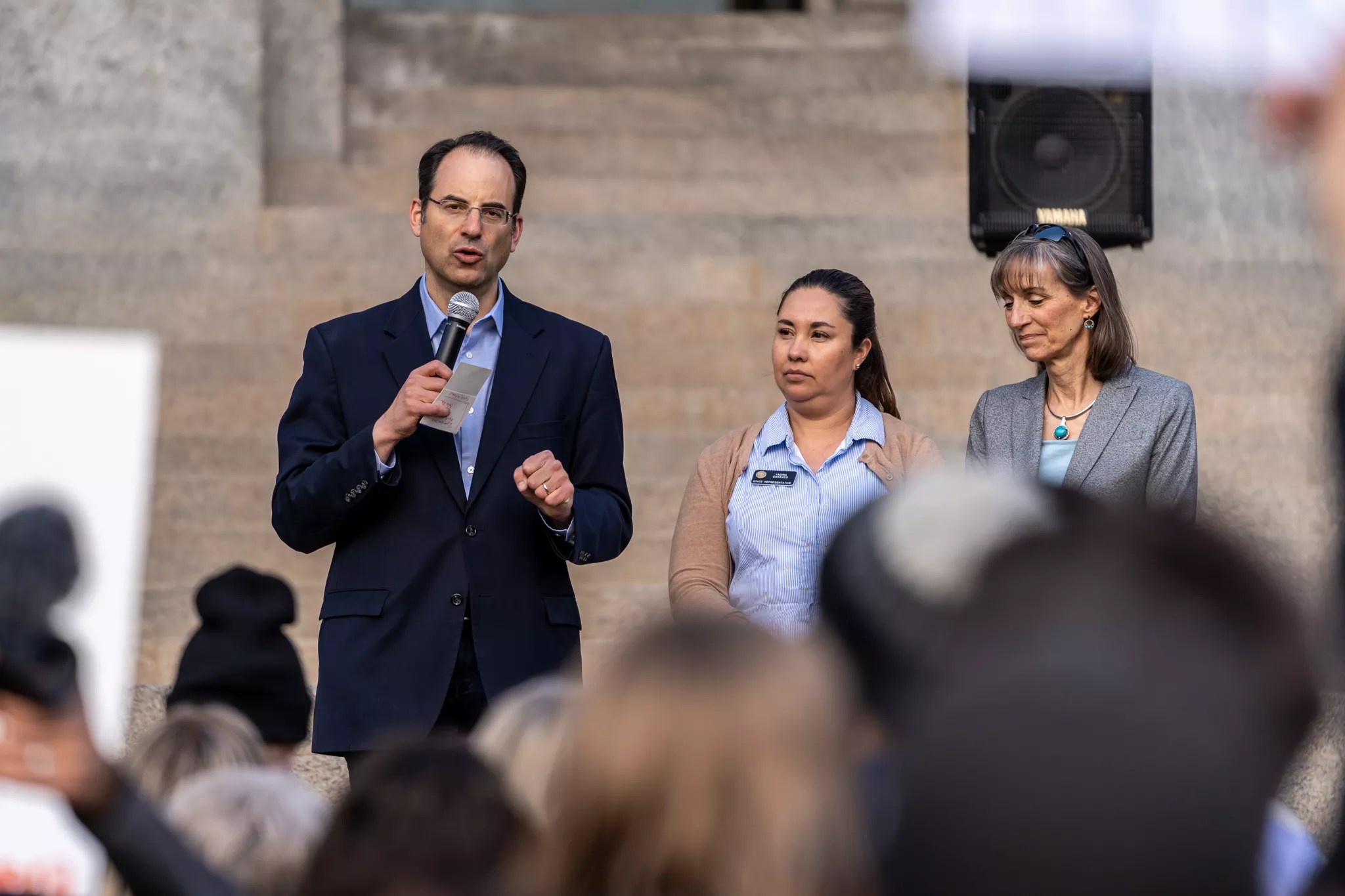 Colorado Attorney General Phil Weiser and Congresswoman Yadira Caraveo speak at a rally.