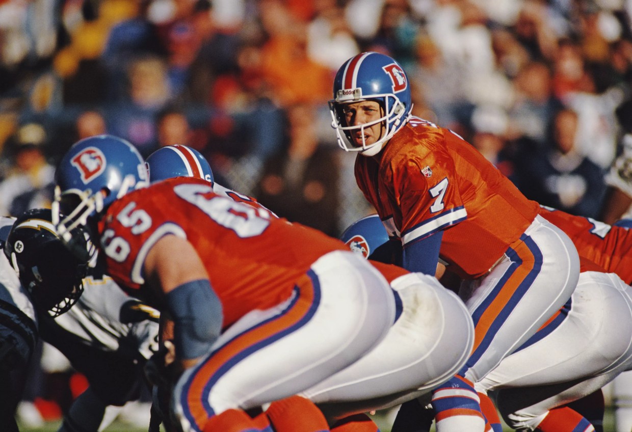 John Elway in bright orange Broncos jerseys