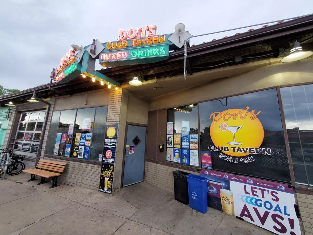 the front of a bar with a neon sign