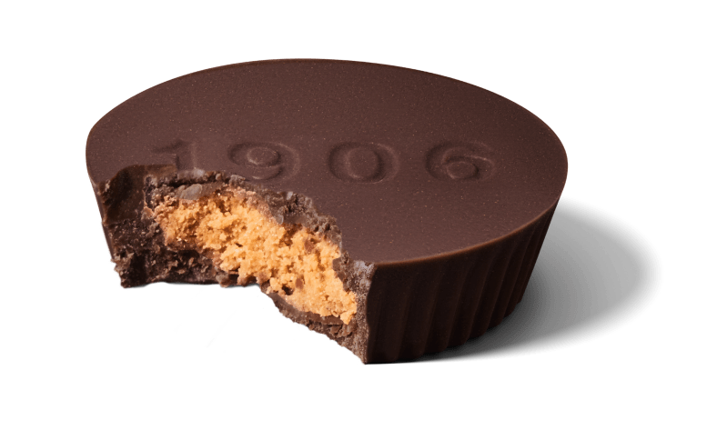 A 1906 chocolate peanut butter cup with a bite taken out