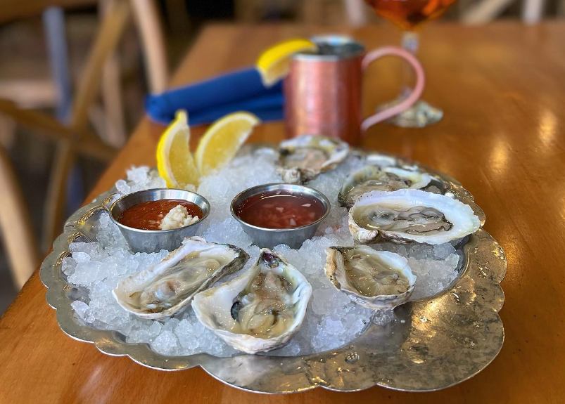 a half dozen oysters on ice