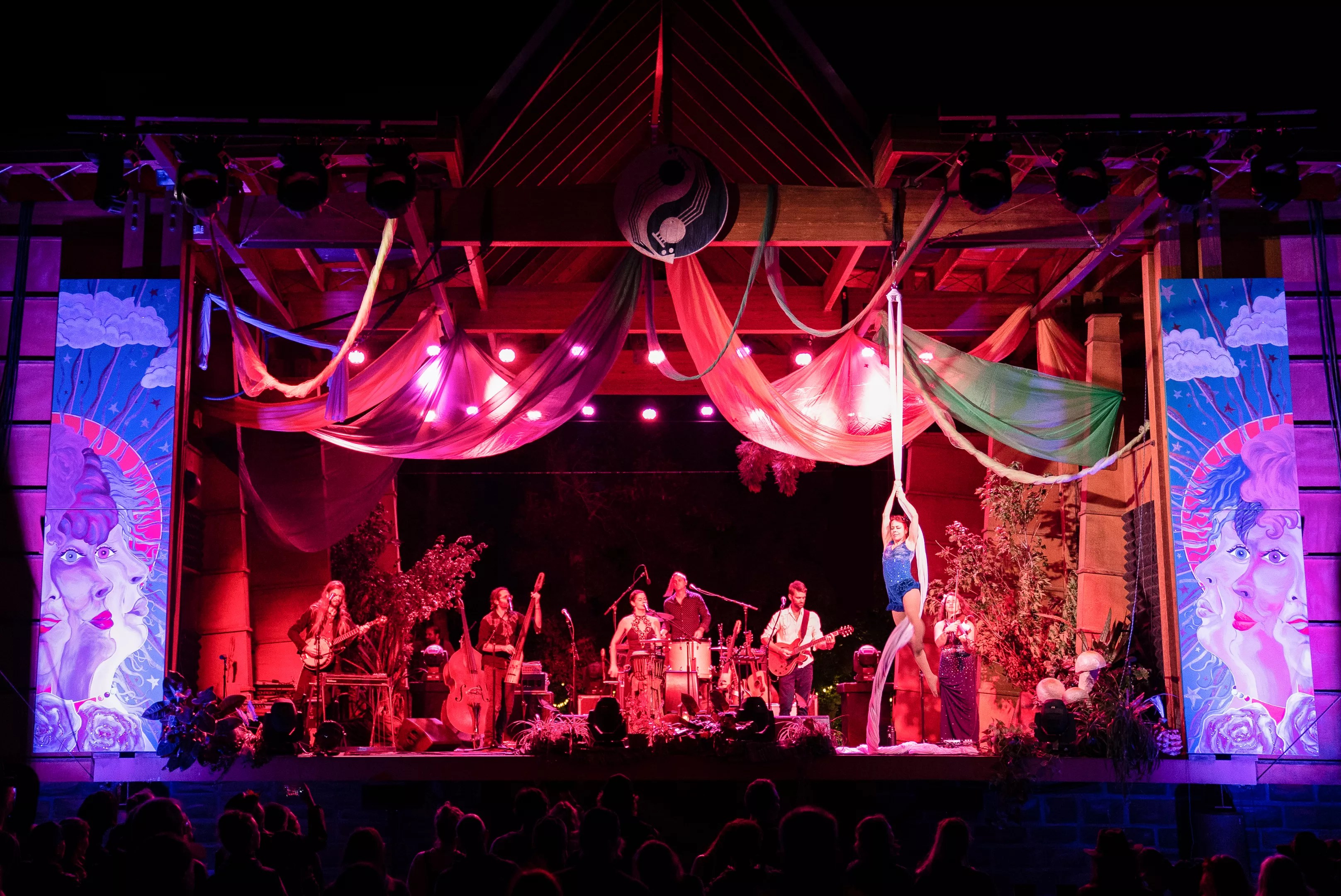 Elephant Revival performing on stage with an aerial silk artist