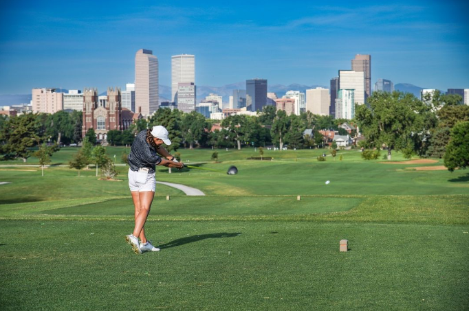 A golfer swings at City Park Golf Course in Denver
