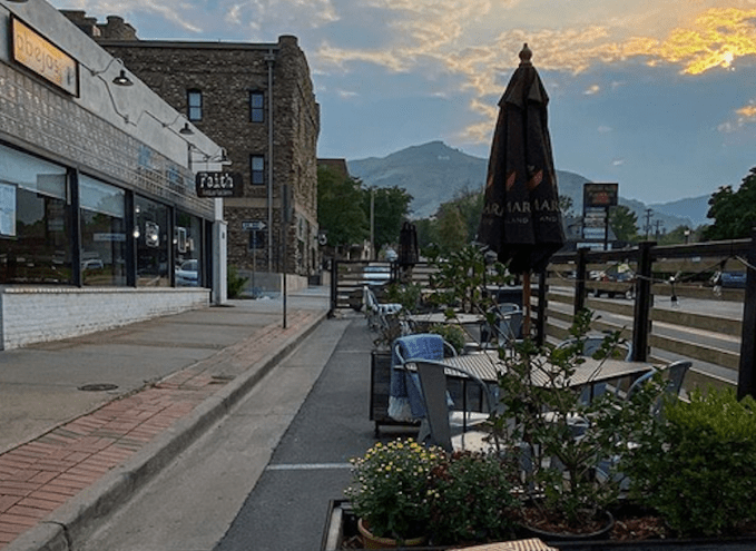 outdoor tables on a street at sunset
