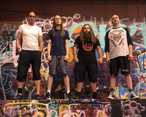 Metal bandmates of narcotic wasteland pose on a persian rug