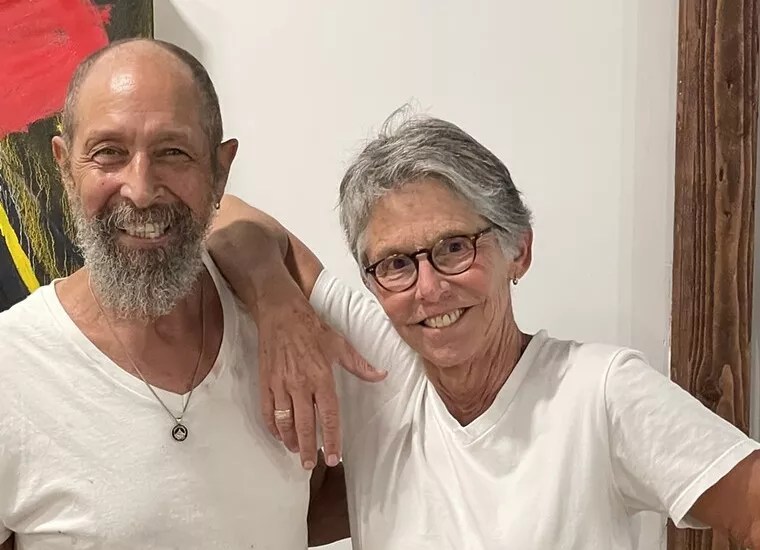 Artists Kathryn Cole and Edgar Dumas pose at their exhibit in 2022.