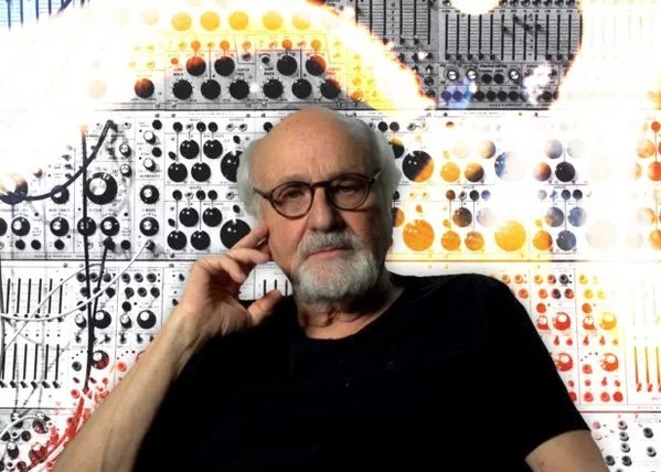 a white man with a beard and glasses in a black shirt