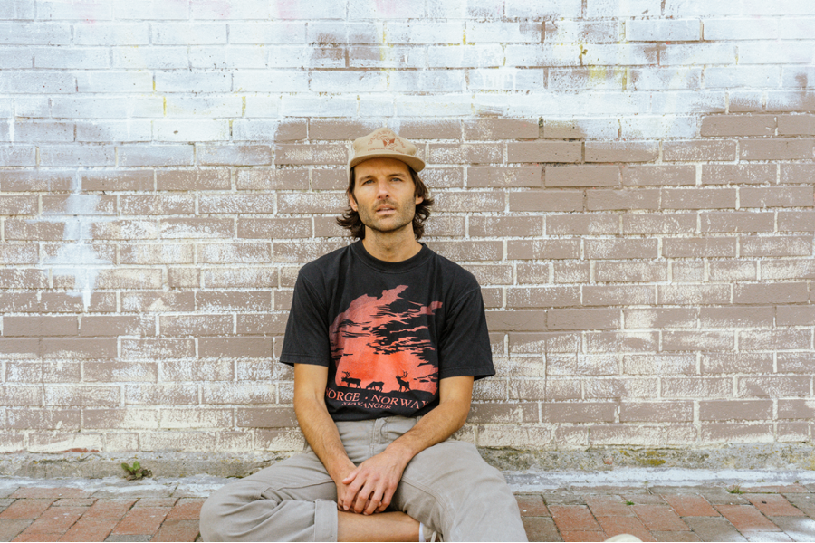 a man sitting down in a yellow hat