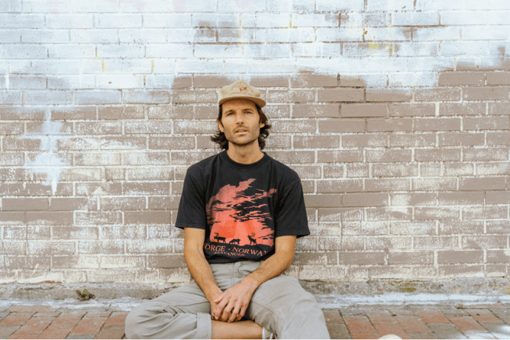 a man sitting down in a yellow hat