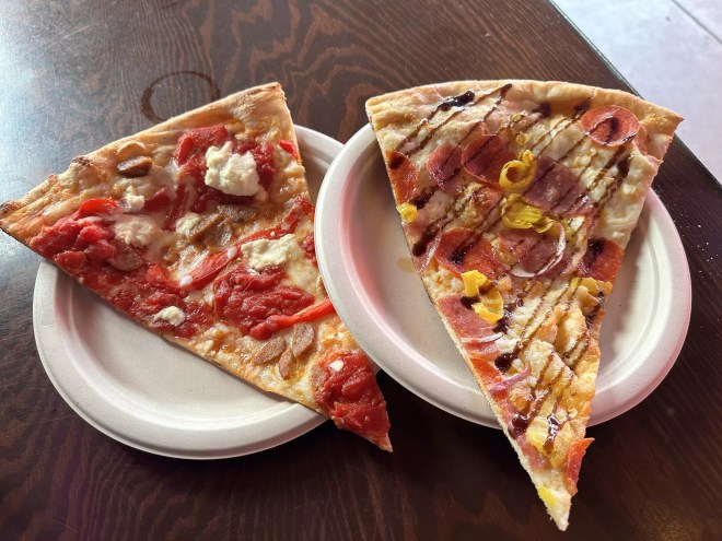 two slices of pizza on paper plates