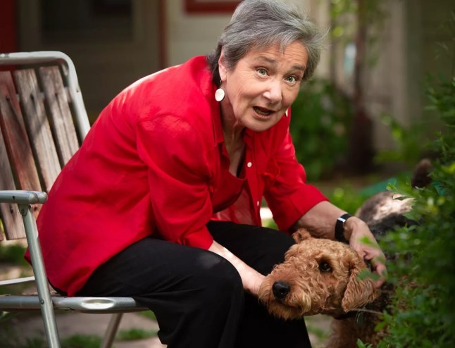 woman in red sweater with dog