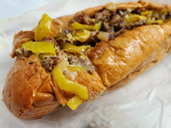 a Philly cheesesteak sandwich with banana peppers