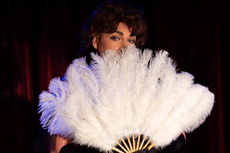 person with feather fan