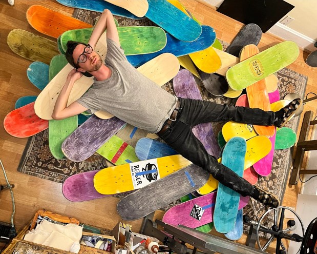 a man lying on top of skateboard decks