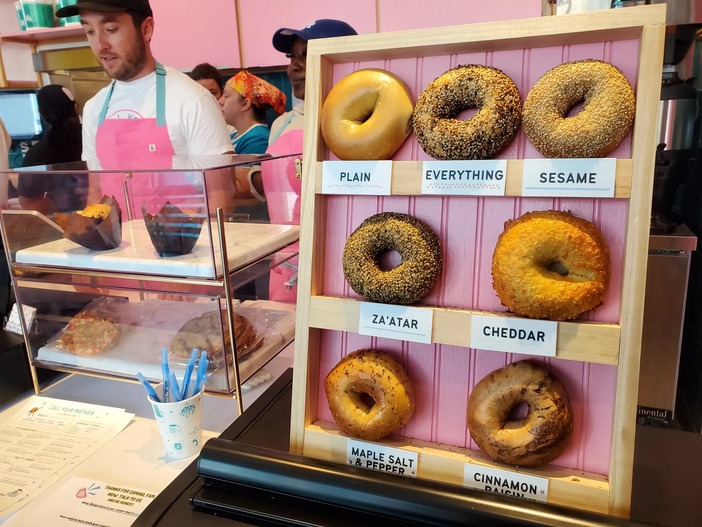 bagels on a vertical display on the counter of a deli