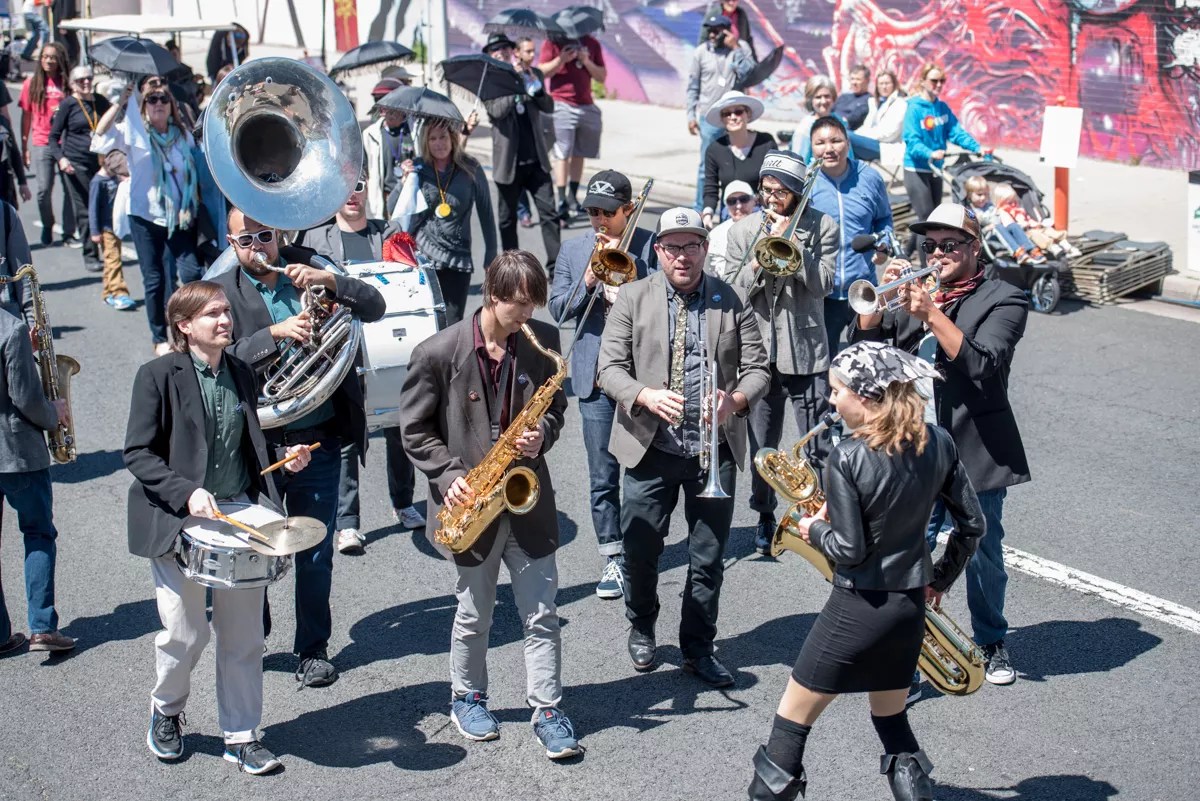 a brass band plays in a parade