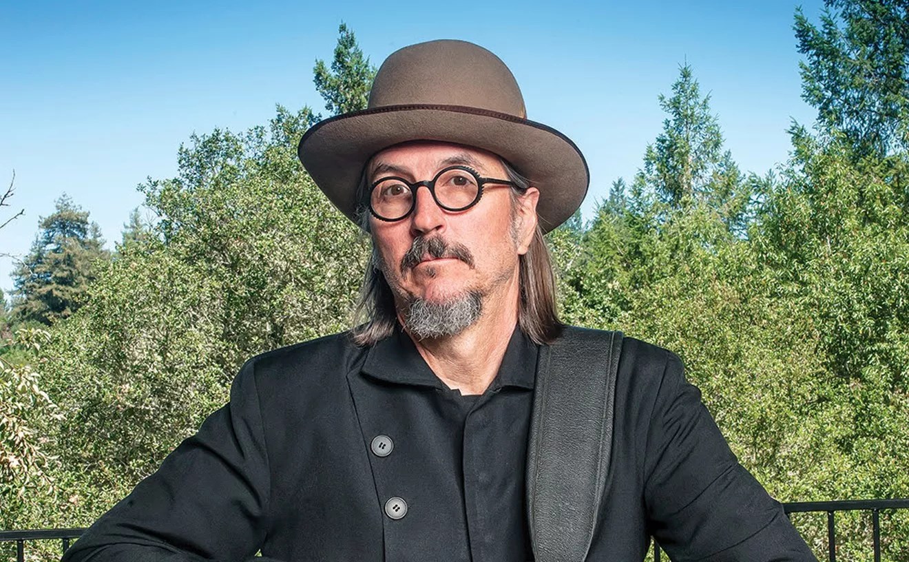 man wearing a hat, glasses and goatee