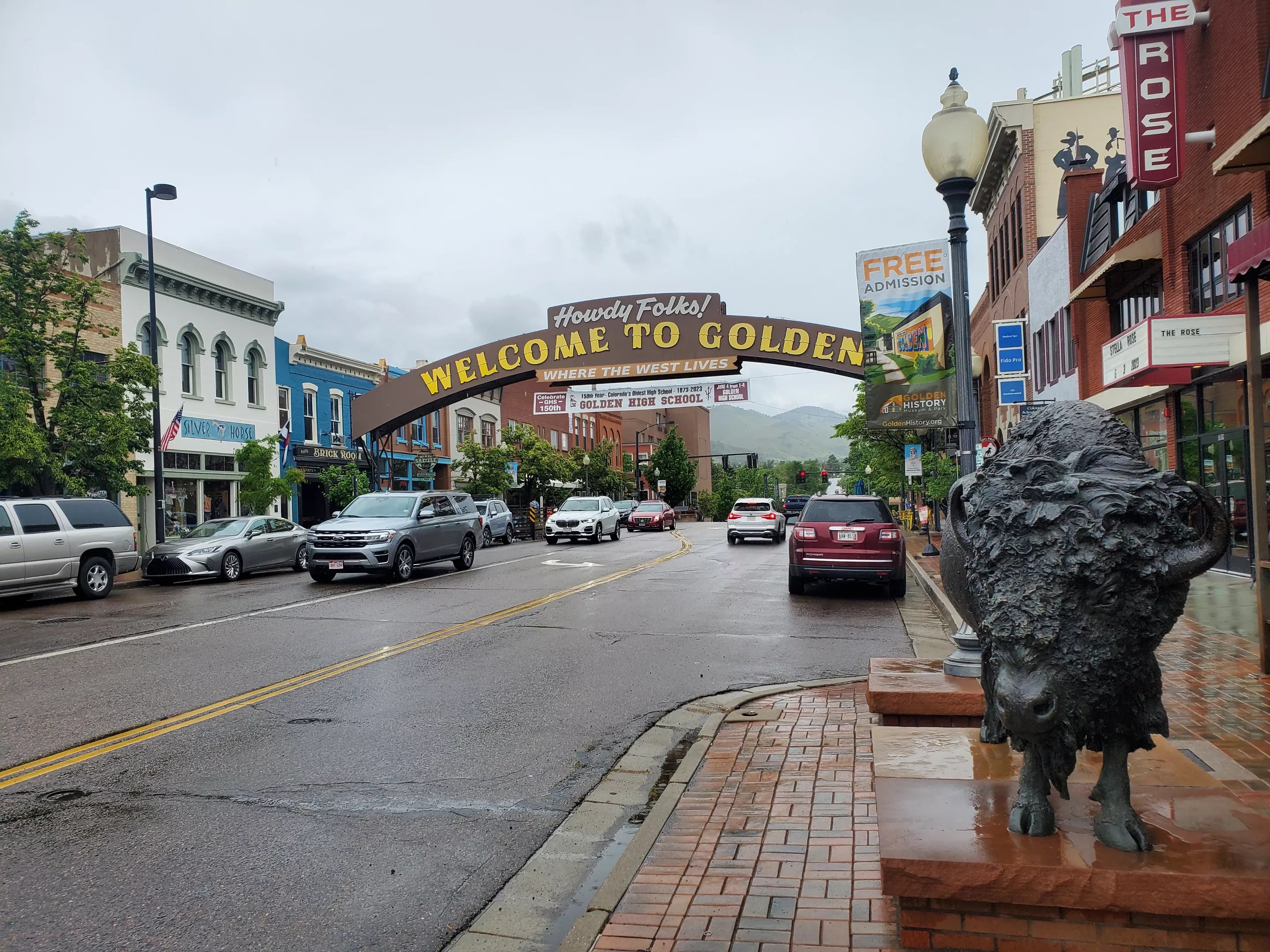a sign arching over a street that says welcome to Golden