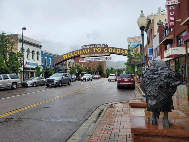 a sign arching over a street that says welcome to Golden