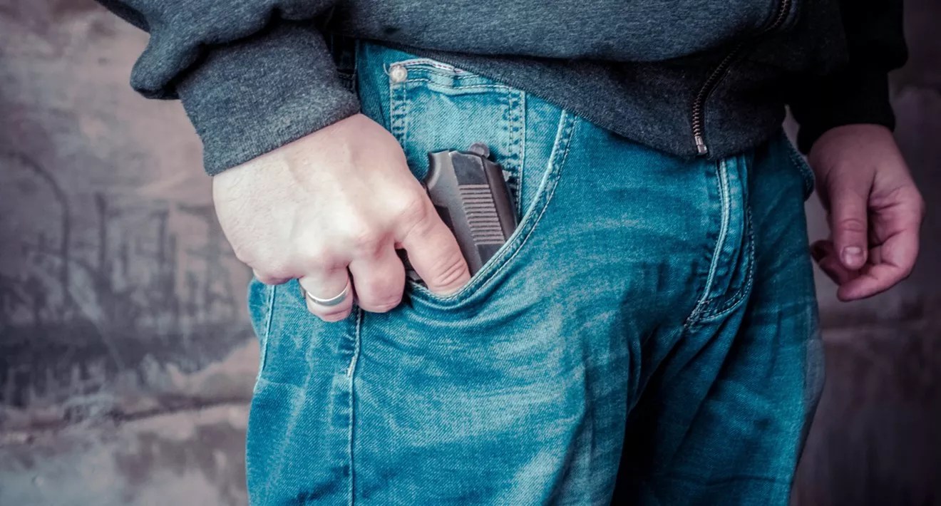 gun in man's jean pocket