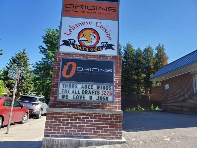 A sign for businesses in a strip mall